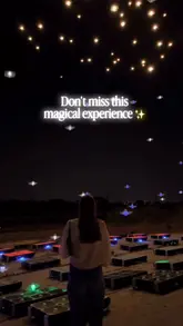 A montage video showcasing a drone art show in Dublin, featuring over 1200 drones creating light displays in the night sky accompanied by a live string quartet and a candlelit setting.