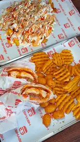 A fast-paced, high-energy montage showcasing various smash burgers, loaded fries, chicken tenders, wings, and drinks at FT.SMASH.