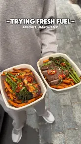 A creator visits Fresh Fuel in Ancoats, Manchester, to review their box meals. The video features a tour of the venue, including the ordering kiosks, and a taste test of their steak and fish boxes with sides.
