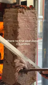 The video features a visit to 'Londöner by Best Mangal' in London, focusing on their wood-fired veal doner. It captures the cooking process, including the meat on the spit and the preparation of dishes like iskender and wraps, alongside shots of the restaurant exterior and side dishes.