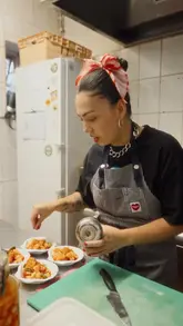 A high-energy, fast-paced vlog featuring a chef preparing and plating various Filipino dishes at a pop-up kitchen called The Scrandit. The video captures the vibrant atmosphere, the cooking process, and the final dishes, highlighting the creator's personality and passion.
