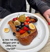 A bright, high-quality overhead shot of a Biscoff French toast dish, effectively capturing the textures and vibrant presentation of the food. The image uses natural lighting and a clean composition to make the brunch item look highly appealing.