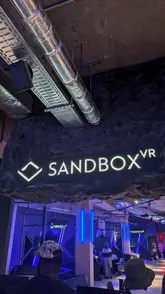 A review of the Squid Game VR experience at Sandbox VR, showing the equipment, gameplay, and the robotic cocktail bar.