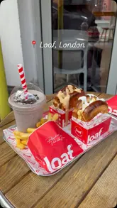 A short promotional video for Loaf, featuring shots of the storefront, the interior, and a tray of food including smash burgers, fries, and milkshakes.