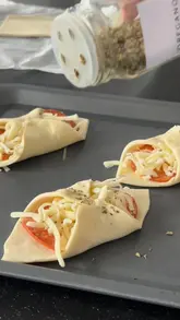 A short, instructional video demonstrating how to make pepperoni and cheese turnovers in an air fryer, featuring a clear step-by-step process from assembly to the final cheese pull.