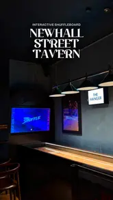 A promotional reel for Newhall Street Tavern in Birmingham, showcasing their interactive shuffleboard tables, cocktail menu, and food offerings like pizza and fried chicken.
