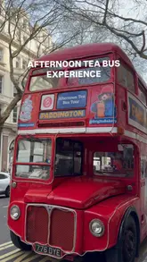 A short, engaging video showcasing the Paddington Bear-themed afternoon tea bus tour in London. The footage captures the exterior of the branded bus, the interior table setting with various afternoon tea treats, and glimpses of the city views, effectively presenting the experience as a fun, family-friendly activity.