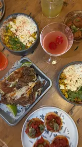 A short, energetic reel showcasing a visit to Taquero restaurant, featuring shots of the exterior, a group toast, close-ups of various Mexican dishes like tacos and tuna tostadas, and the restaurant interior.