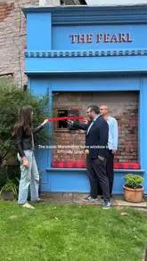 A short, energetic reel showcasing the opening of a wine window at The Pearl in Manchester, featuring customers ordering drinks and enjoying the atmosphere with live music.