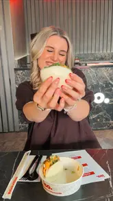 A creator visits the new iso. sushi location in Crewe, showcasing the restaurant's interior, neon signage, and a variety of menu items including bao buns, sushi rolls, katsu, and mochi. The video captures the experience of the opening event, highlighting the casual dining atmosphere.