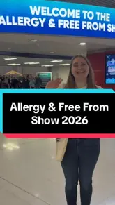 A vlog-style recap of the Allergy & Free From Show, featuring the creator exploring various stalls, interacting with exhibitors, and showcasing a large haul of gluten-free products.