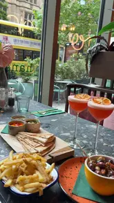 A promotional reel for Manchester Cocktail Week featuring visits to three different venues: The Liquor Store, Banyan, and Motley. The creator highlights the event, showcases signature cocktails and small plates at each location, and provides a call to action to purchase wristbands.