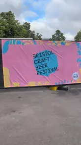 A fast-paced, handheld-style reel showcasing the Bristol Craft Beer Festival. The video features a variety of craft beers and ciders being poured and enjoyed, alongside shots of festival food including scotch eggs, a rice bowl, a burger, and pizza. The creator is featured throughout, highlighting the event's social atmosphere.