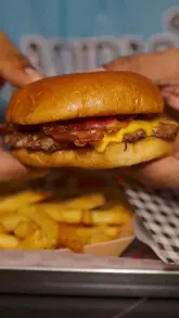 A food review of Simply Smashed featuring a burger, fries, wings, and a milkshake, highlighting a £10 meal deal and World Cup offers.