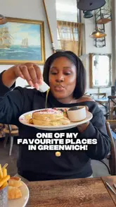 A vlog-style review featuring a creator and her father visiting River Gardens Cafe in Greenwich. The video showcases a variety of dishes including pancakes, chicken skewers, fish and chips, salad, and sticky toffee pudding, while also highlighting the venue's waterside location and addressing a misconception about their opening status due to nearby scaffolding.