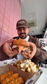 A creator reviews a limited-edition collaboration burger at Dash Burger in Dublin, showcasing the burger, truffle parmesan fries, and buffalo ranch chicken tenders.