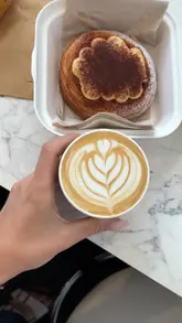 A short video review of The Curator, a cafe located in Plymouth Market. The creator highlights the Italian-inspired pastries, wood-roasted coffee, and the unique 1970s mural found in the venue.