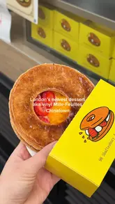 A short, punchy video showcasing a new dessert spot in London's Chinatown, specifically highlighting their unique 'vinyl' mille-feuille pastry. The video includes shots of the assembly process, the finished product, and the shop's interior and exterior.