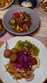 A montage video showcasing a variety of small plates, cocktails, and desserts at a Lounge-style venue, highlighting the social dining experience and menu diversity.