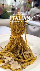 A montage showcasing the food and outdoor terrace of Tozi restaurant in Battersea, London. The video features close-ups of various Italian dishes, including truffle pasta, arancini, and desserts, alongside shots of drinks and the venue's outdoor seating area with live music.