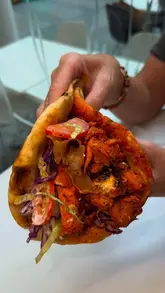 A montage showcasing the preparation and serving of fish and chips and kebabs at Tasty Plaice. The video features close-up shots of the food being prepared, dipped in sauces, and presented, focusing on the textures and portion sizes.