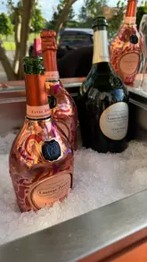 A promotional reel showcasing the Laurent-Perrier Champagne Garden pop-up at The Celtic Manor Resort. The video features aesthetic shots of champagne service, floral decor, canapés, and interactive elements like a 'Ring for Champagne' bell, set to music.
