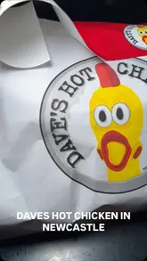 A short, punchy video showcasing a takeaway meal from Dave's Hot Chicken in Newcastle, featuring close-up shots of fried chicken tenders, crinkle-cut fries, and a chicken burger being dipped in sauce.
