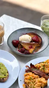 A short, aesthetic reel showcasing a brunch visit to Minnow in Clapham, featuring shots of the exterior, interior, iced drinks, avocado toast, and French toast.