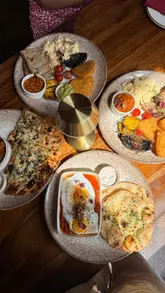 A short, edited montage showcasing a brunch visit to Passan's in Nottingham, featuring close-ups of Indian-inspired breakfast dishes, tea service, and the restaurant's colorful interior decor.