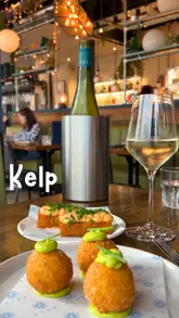A polished montage showcasing a variety of seafood-focused small plates, cocktails, and the interior of Kelp restaurant in Glasgow. The video focuses on high-quality close-ups of the food and drink presentation, creating an inviting and upscale atmosphere.