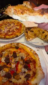 A short, energetic video showcasing a lunch date at Pizza Punks, featuring close-ups of pizzas, chicken wings, cocktails, and the restaurant's interior, along with a glimpse of their menu and lunch deal.