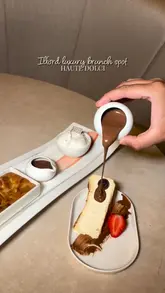 A short, aesthetic reel showcasing the interior and menu offerings of Haute Dolci in Ilford, featuring shots of pasta, cheesecake, cookie dough, and drinks.