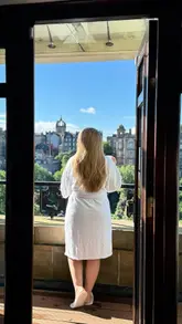 A serene hotel room tour showcasing a room with a balcony and panoramic views of Edinburgh, including the Scott Monument and Edinburgh Castle.