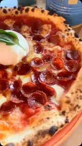 A review-style video showcasing a visit to Leopardo Pizza, featuring shots of their signature pizzas, the menu, the restaurant interior, and the takeaway experience.