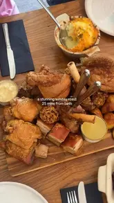 A short video showcasing a Sunday roast sharing platter at The Wiltshire Yeoman in Trowbridge. The video features close-up shots of various meats, sides like cauliflower cheese and pigs in blankets, and desserts, followed by a shot of the pub's exterior.