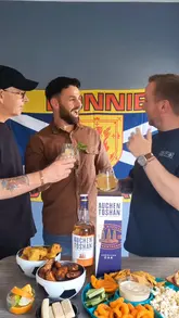 A sponsored video featuring three men preparing and enjoying whisky cocktails at home while watching a sports match, promoting Auchentoshan American Oak whisky.