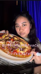 The video is a fast-paced, creator-led vlog reviewing the bottomless brunch offering at a specific Pizza Express location (The Pheasantry, Chelsea). It features the creator walking through the venue, showing the welcome drinks, the variety of cocktails and prosecco, the starters (chicken wings and calamari), and the main course pizzas. The video emphasizes the lively atmosphere, including a DJ playing R&B music, and mentions the specific offer details like the 90-minute free-flowing drinks and the birthday/hen-do perk.