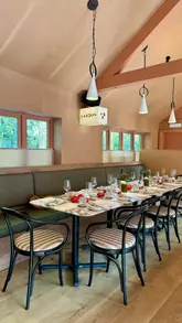 A montage showcasing a new restaurant called Lardon in the Cotswolds, featuring a variety of Mediterranean-inspired small plates, main courses, and desserts, alongside the venue's interior and atmosphere.