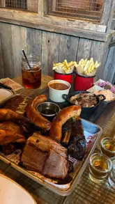 A short, energetic reel showcasing a visit to Hickory's Smokehouse. The video features the exterior, interior, drinks, and a large meat platter, providing a good overview of the dining experience.
