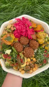 A montage of fresh salad bar options, falafel, and smoothies at a Go Falafel location, showcasing the variety and freshness of the food on offer.