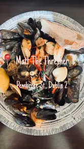 A montage-style video showcasing the interior, exterior, and various seafood dishes at Matt The Thresher in Dublin. The video transitions through starters, mains, and the bar area with text overlays describing the items.