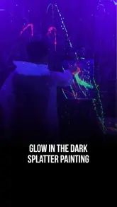 A short, energetic video showcasing a glow-in-the-dark splatter painting experience at Kedi Studio. The footage captures the chaotic, creative fun of the activity under UV lights, highlighting the protective gear and the painting process.