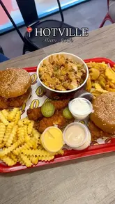 A promotional video for the opening of Hotville in Alum Rock, featuring close-up shots of burgers, loaded fries, and chicken tenders being dipped in sauce. The video highlights the food and the opening offer.