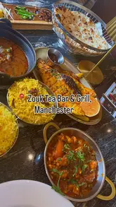 A promotional video for Zouk Tea Bar & Grill in Manchester, featuring a montage of the restaurant's exterior, interior, and a variety of Indian and Pakistani dishes and cocktails.