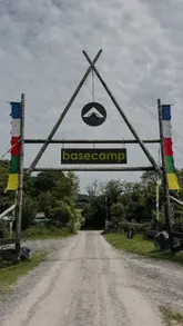 A montage video showcasing a family-friendly camping and activity centre, featuring live music, outdoor games like frisbee golf, a slide, fire pits for toasting marshmallows, and casual dining.