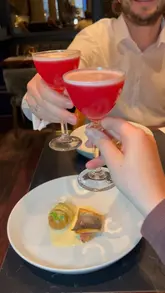 The video features a couple enjoying a global-themed tasting menu at Six By Nico. It includes close-up shots of various courses, cocktails, and the dining atmosphere, providing a clear overview of the experience.