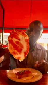 Two creators visit Ember Yard, a restaurant in London, to review their tapas menu. The video features a tour of the venue, shots of the food being prepared in an open kitchen, and the creators tasting various dishes and cocktails, providing their positive feedback throughout.