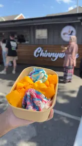 A short, punchy video showcasing a variety of desserts from a food truck, including mango ice cream, donuts, and chocolate-covered cakes.