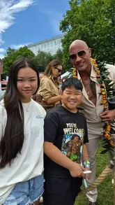 A handheld vlog capturing a promotional event for the live-action Moana movie in London, featuring interactions with Dwayne Johnson, Auli'i Cravalho, and Catherine Laga'aia, alongside a live performance.