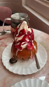 A montage showcasing the aesthetic interior and menu items at Le Café by Nicolas Rouzaud, featuring close-ups of pastries, brunch dishes like eggs benedict, and drinks.